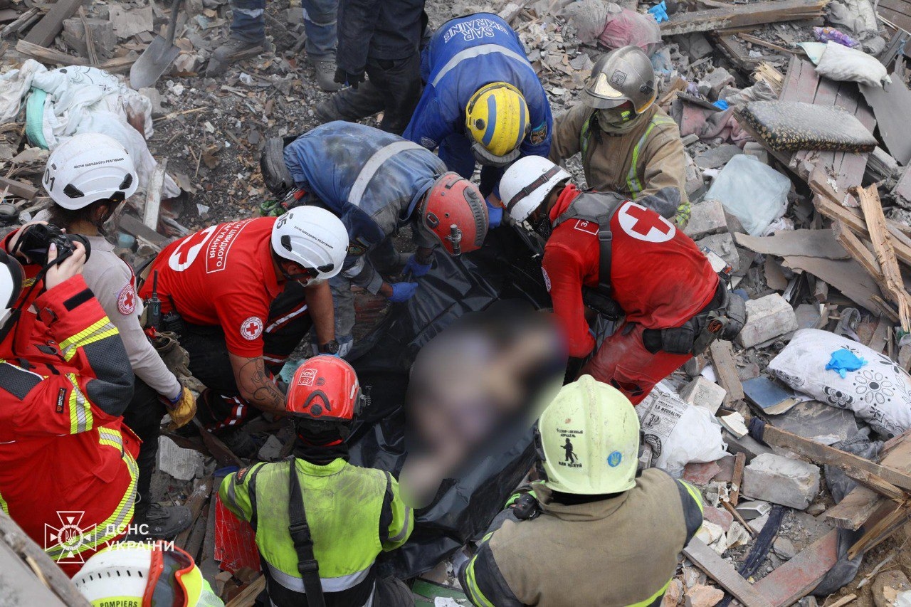 Emergency workers preparing to transport a body pulled out from under the rubble of a building in Kyiv, Ukraine, on April 24.