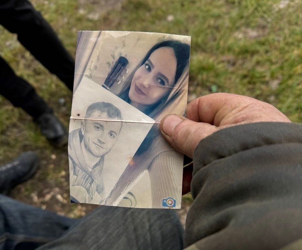 Анатолий Куличенко показывает фотографию убитого сына Евгения и его невесты
