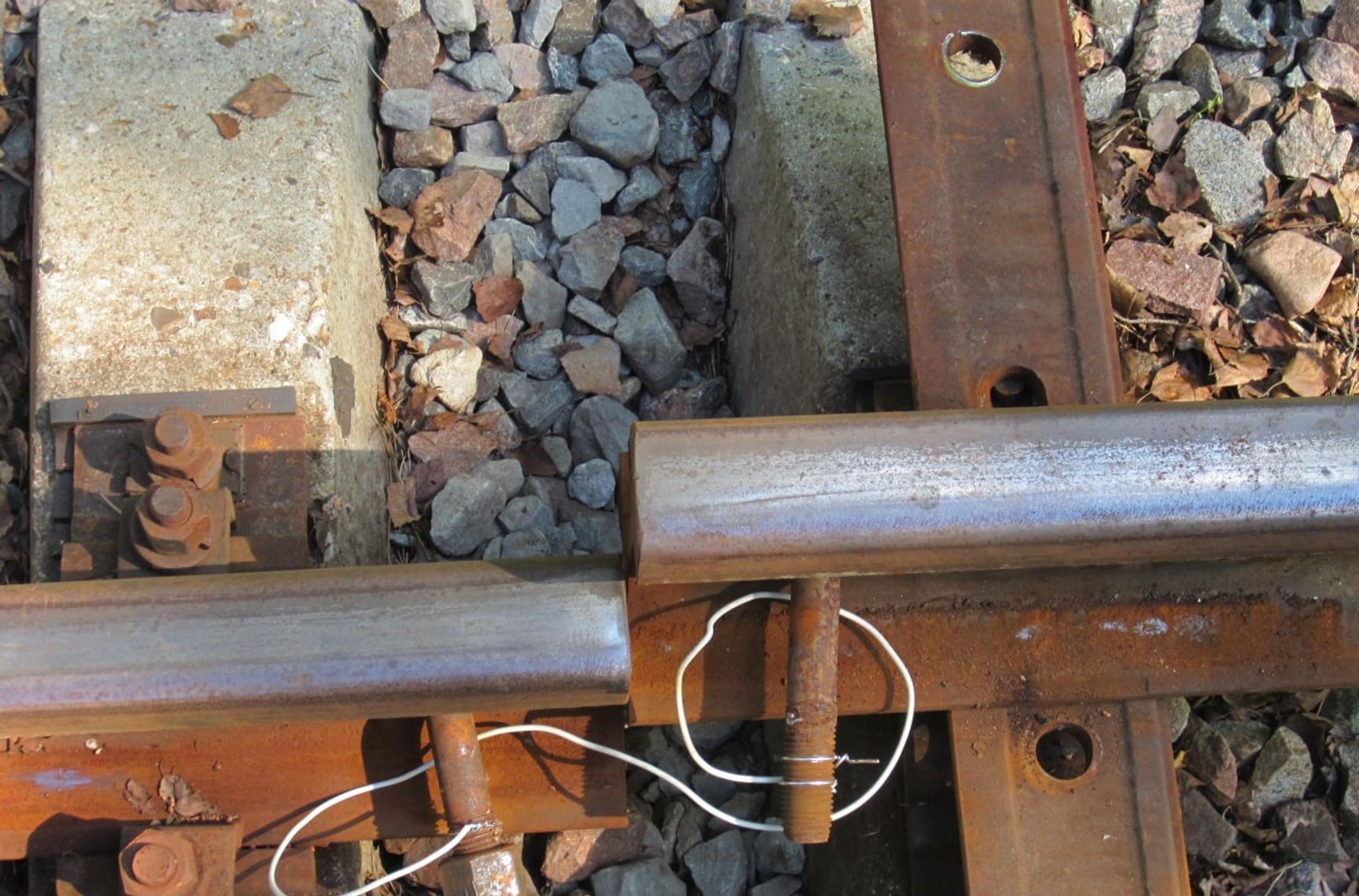 Sabotaged railroad siding leading to a military unit. The rails are shorted with a wire to prevent signaling current from detecting a gap