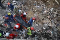 Emergency workers carrying a body pulled out from under the rubble of a building in Kyiv, Ukraine, on April 24.