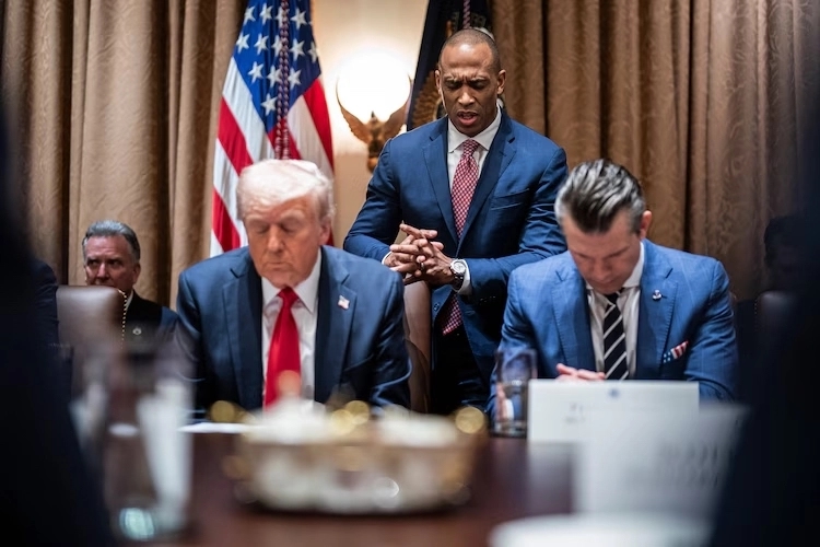 Housing and Urban Development Secretary Scott Turner prays while President Donald Trump and Pete Hegseth listen during a cabinet meeting on February 26, 2025.