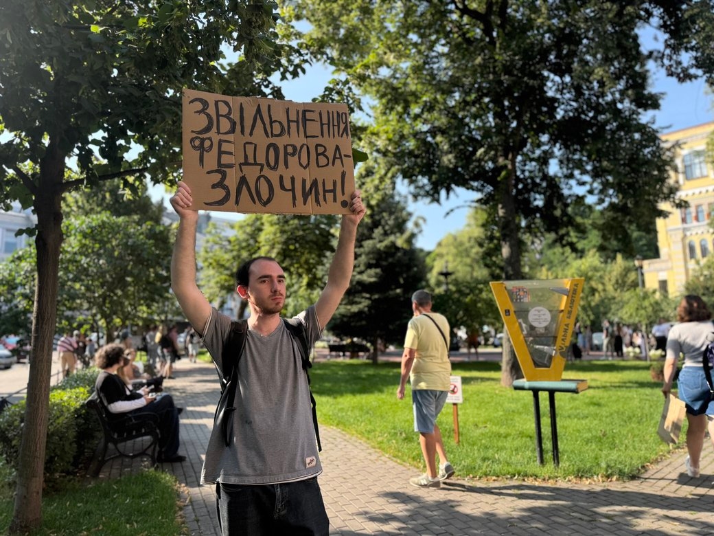 A man holding a placard reading “Fedorov’s dismissal is a crime!” in Kyiv on July 16, 2026
