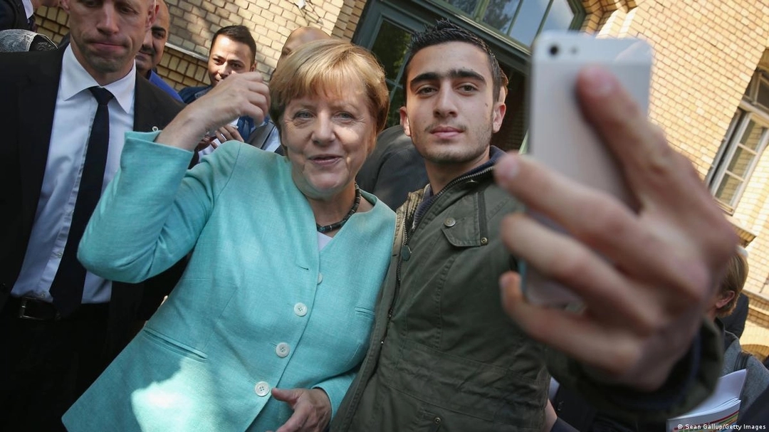 Former German Chancellor Angela Merkel posing for a selfie with Anas Modamani, a Syrian refugee, in Berlin in September 2015