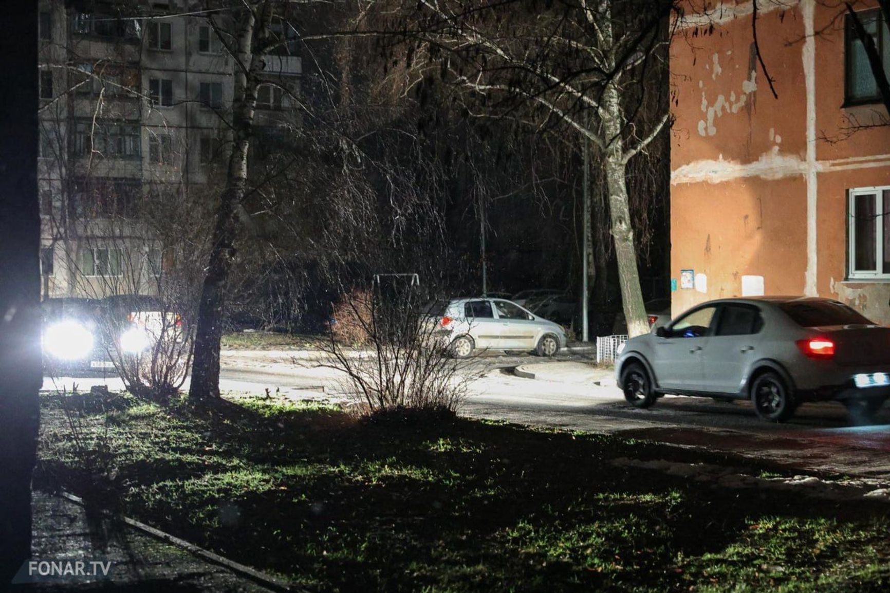 Cars light up a courtyard in one of Belgorod's residential areas during a blackout