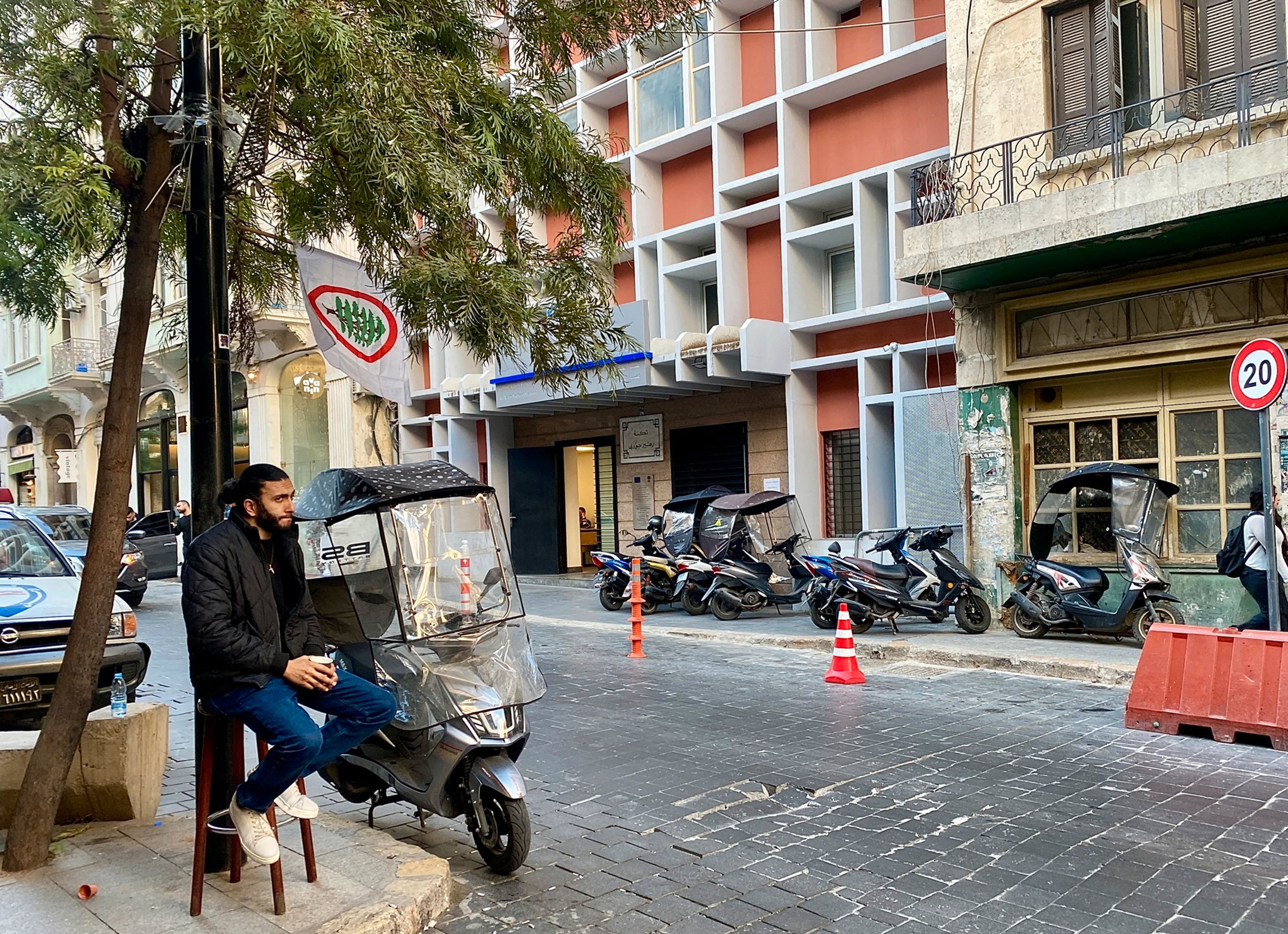 A Syrian refugee on Rue Armenia. Many of the Syrians fleeing the war travel on scooters with plastic windshields