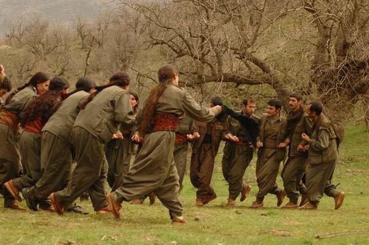 PKK guerrillas perform a Kurdish folk dance