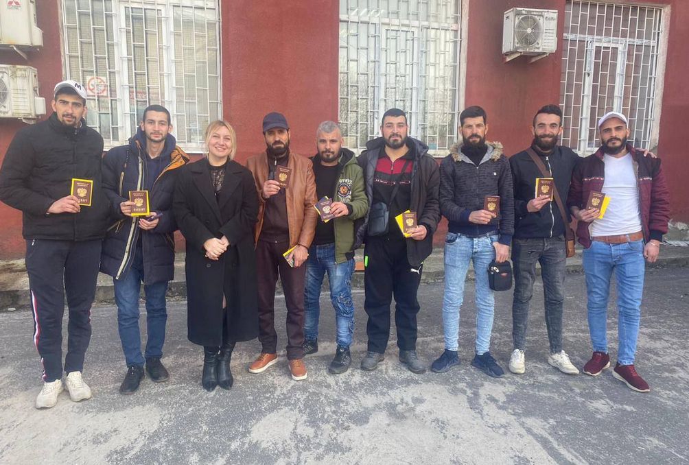 Wahid Mursala al-Shibli receives his Russian passport (third from right)