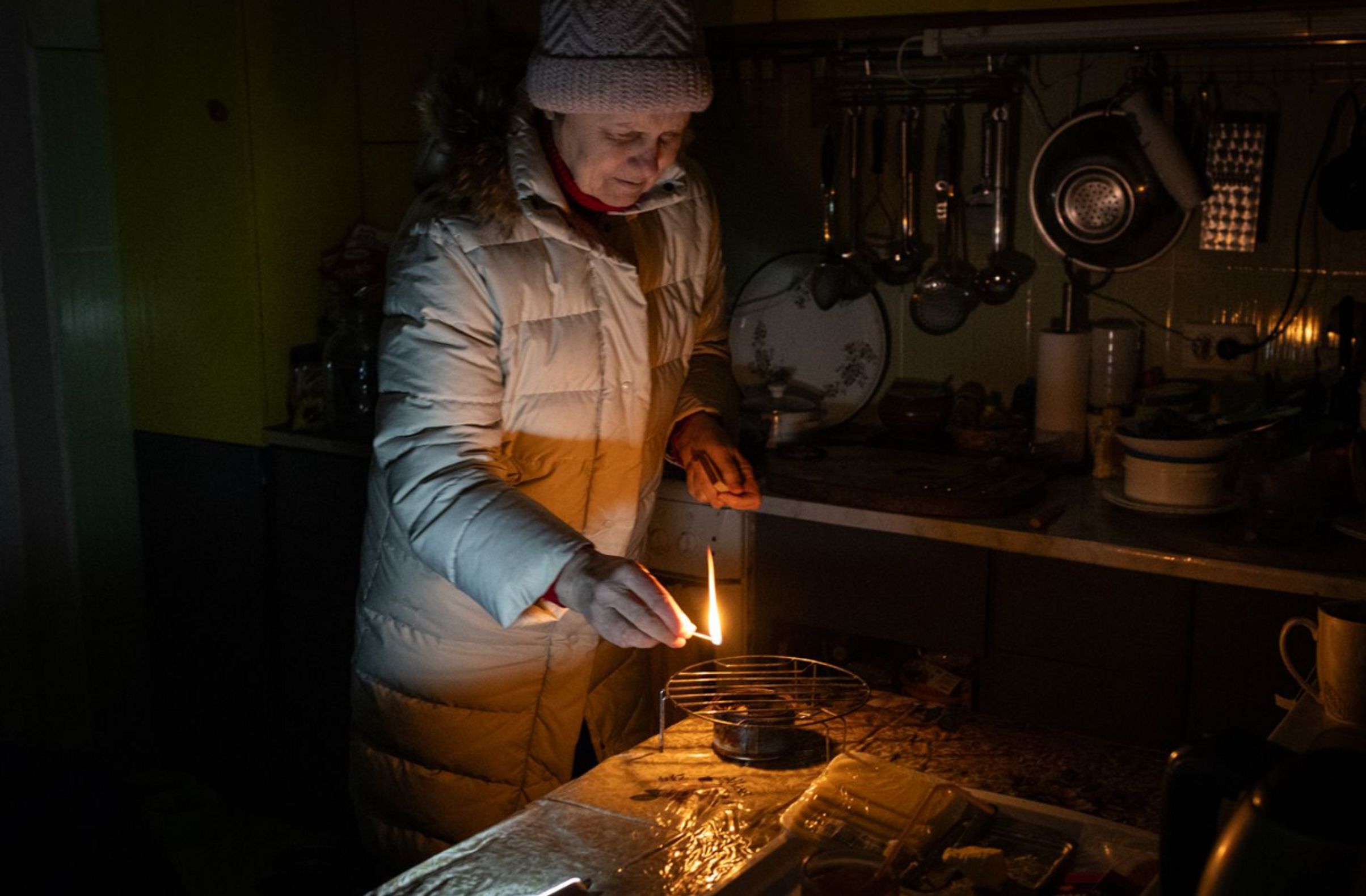 A Kyiv resident lights a candle in her apartment