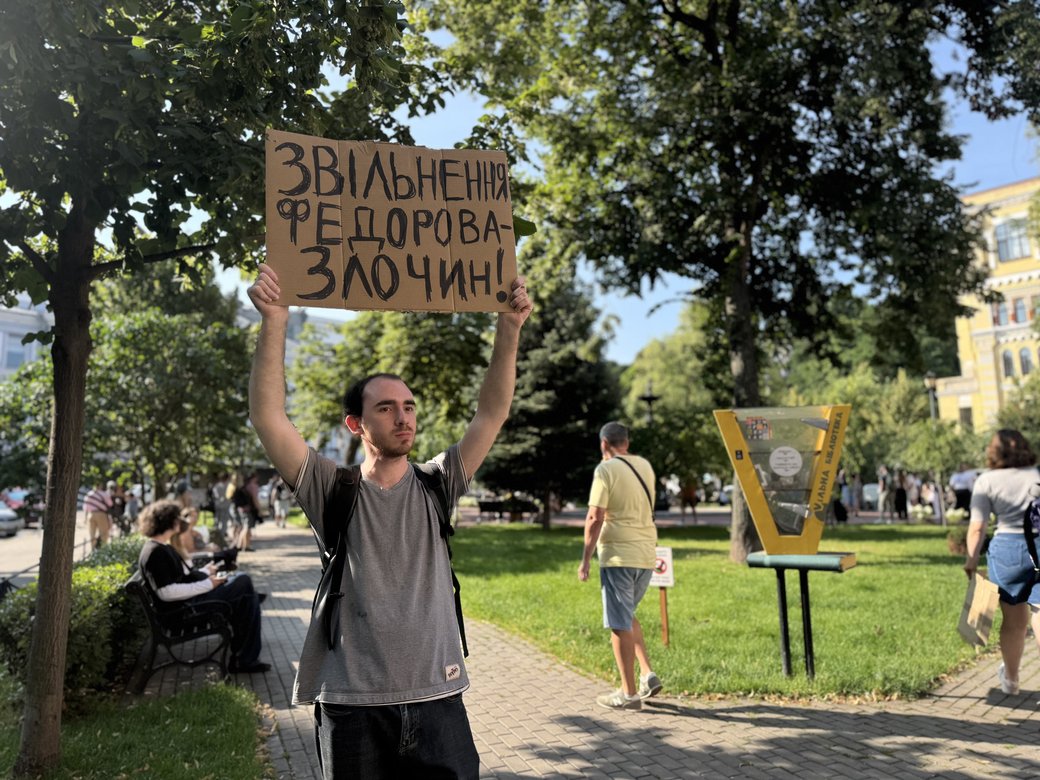 A man holding a placard reading “Fedorov’s dismissal is a crime!” in Kyiv on July 16, 2026
